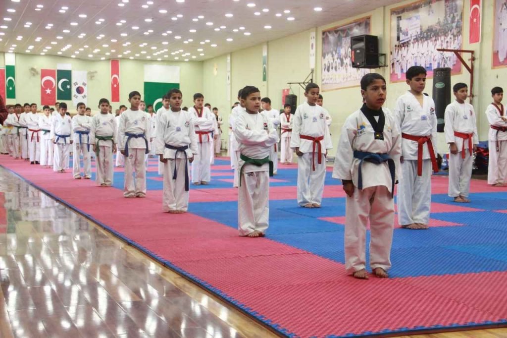 Taekwondo students training at Khubaib Academy in Haripure during an outdoor session.
