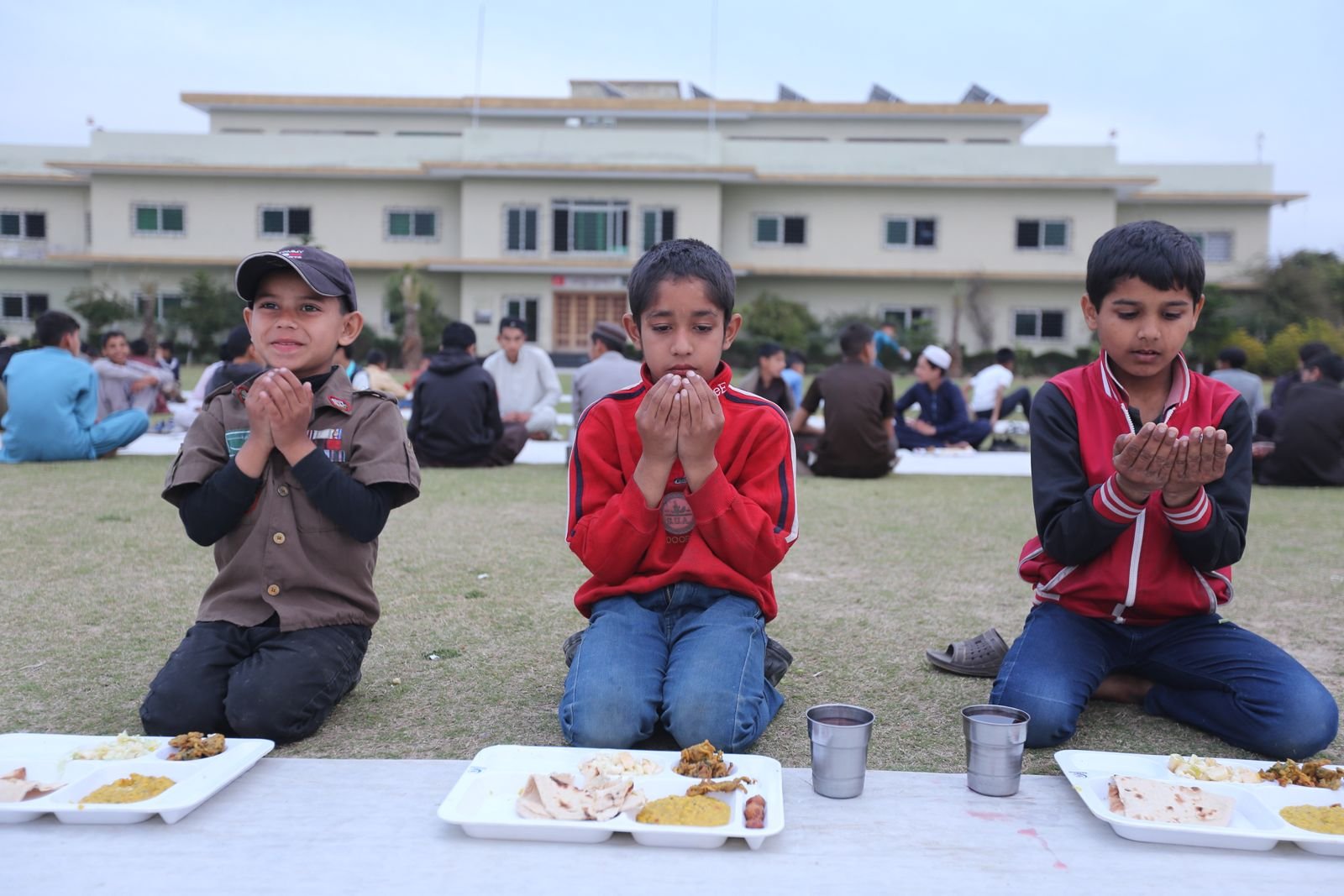 Students at Khubaib College in Haripure during Iftar prayer.