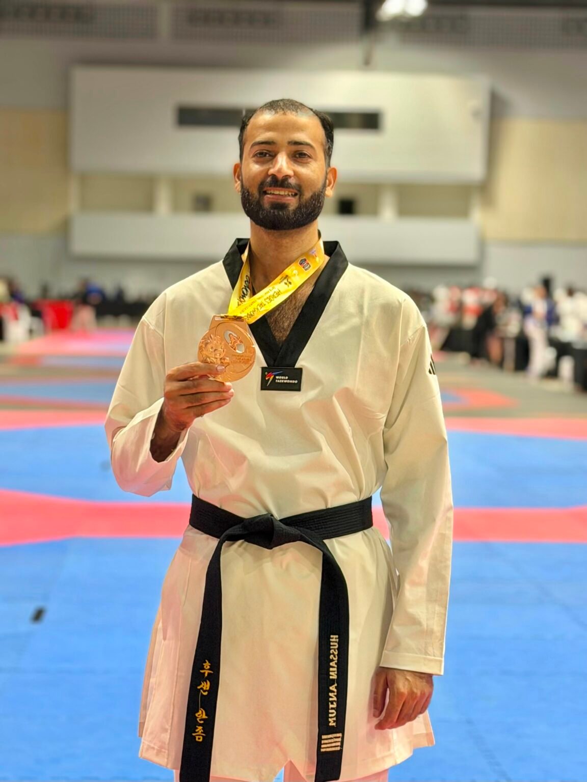 Hussain Anjum of Khubaib Foundation holding his bronze medal at the Heroes Cup Taekwondo Championship in Thailand