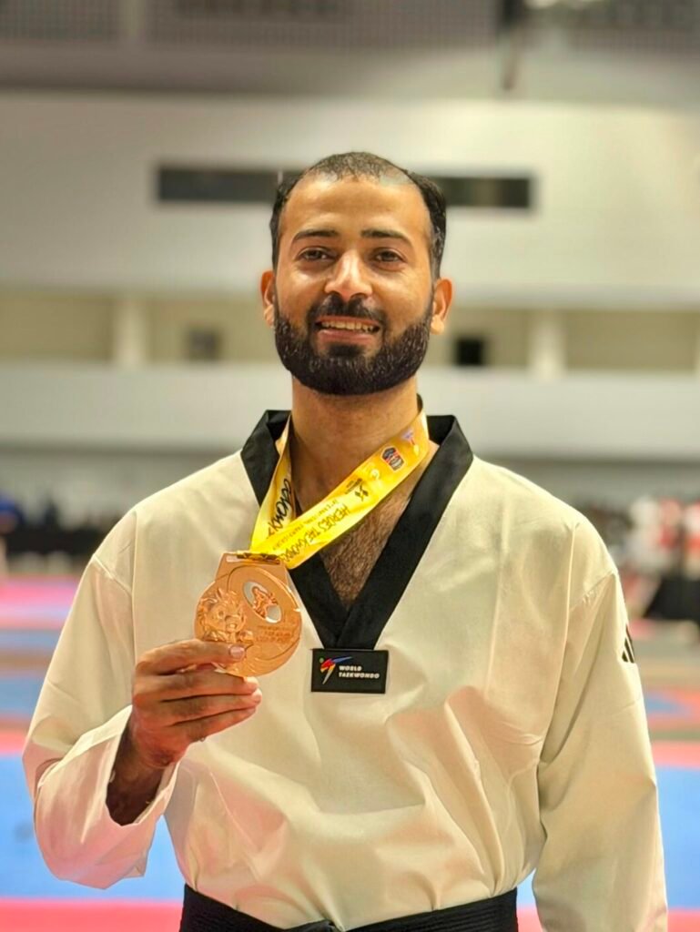 Hussain Anjum of Khubaib Foundation holding his bronze medal at the Heroes Cup Taekwondo Championship in Thailand