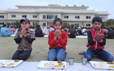 Students at Khubaib College in Haripure during Iftar prayer.